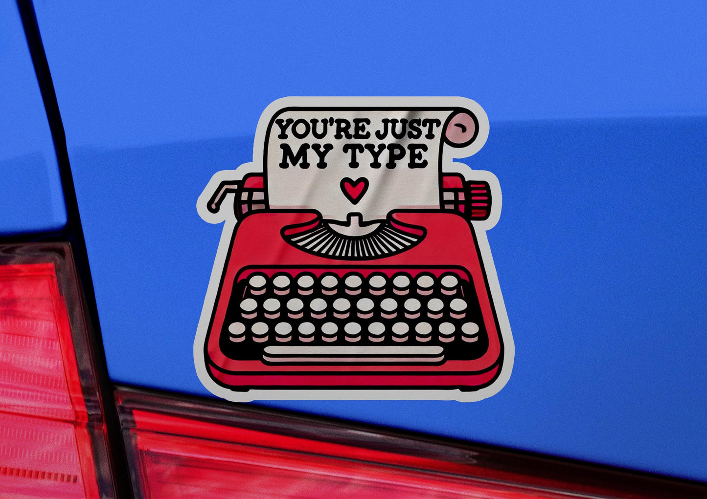 a car with a sticker of a typewriter