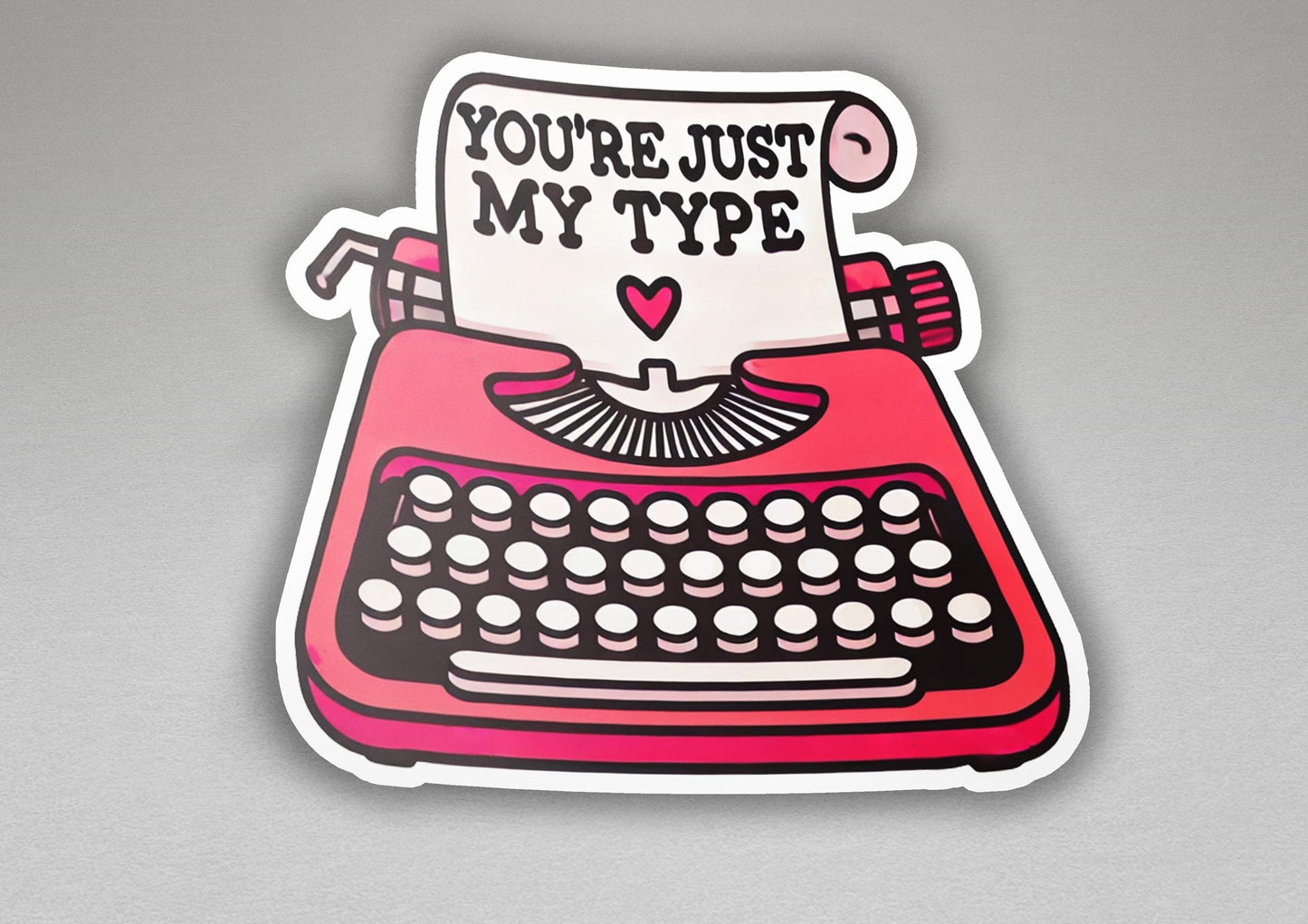a sticker of a typewriter with a sign that says you're just