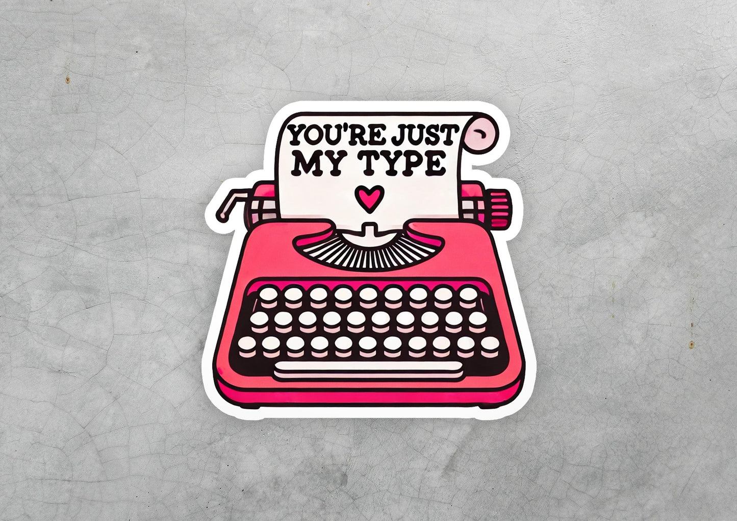 a sticker of a typewriter with the words you're just my type