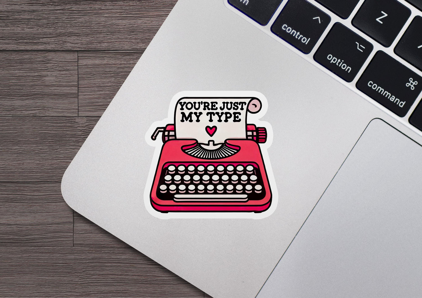 a laptop with a sticker of a typewriter