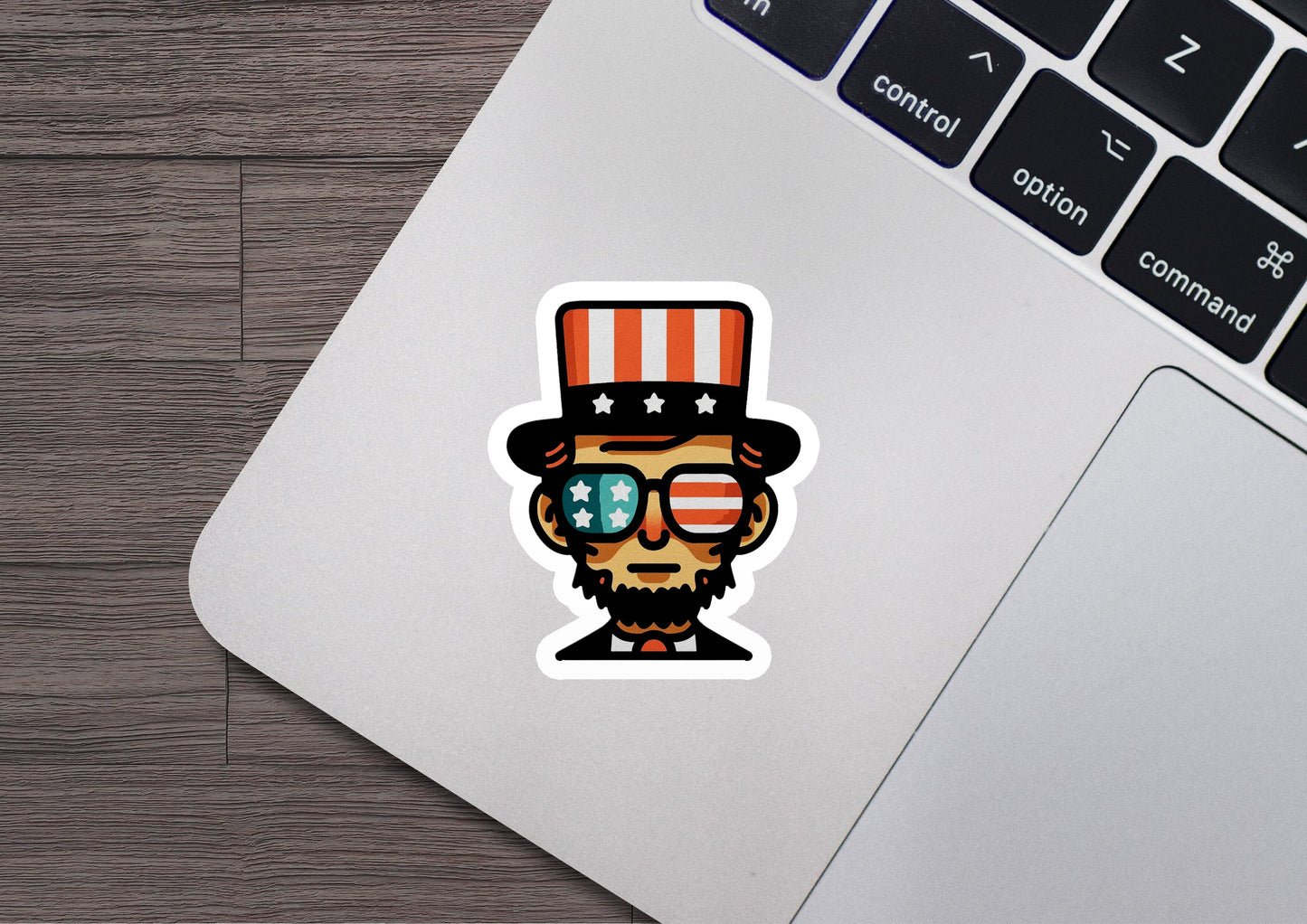 a laptop with a sticker of a skull wearing a top hat