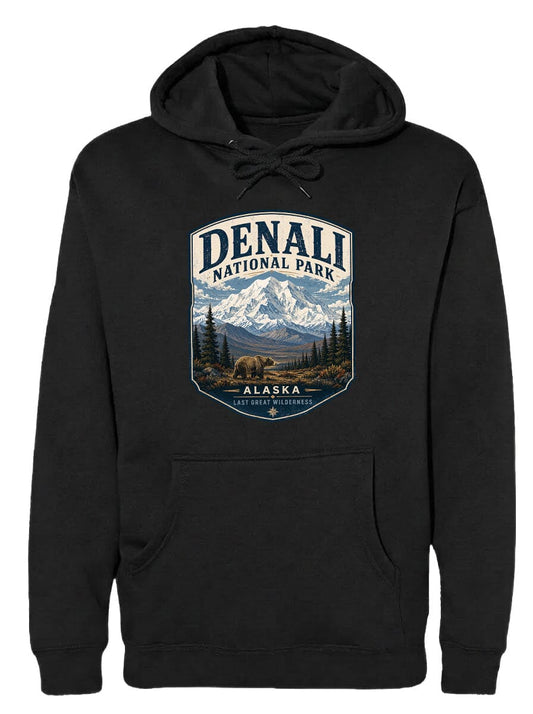 A black hoodie with a graphic design depicting Denali National Park in Alaska, featuring a mountain landscape with a bear in the foreground.
