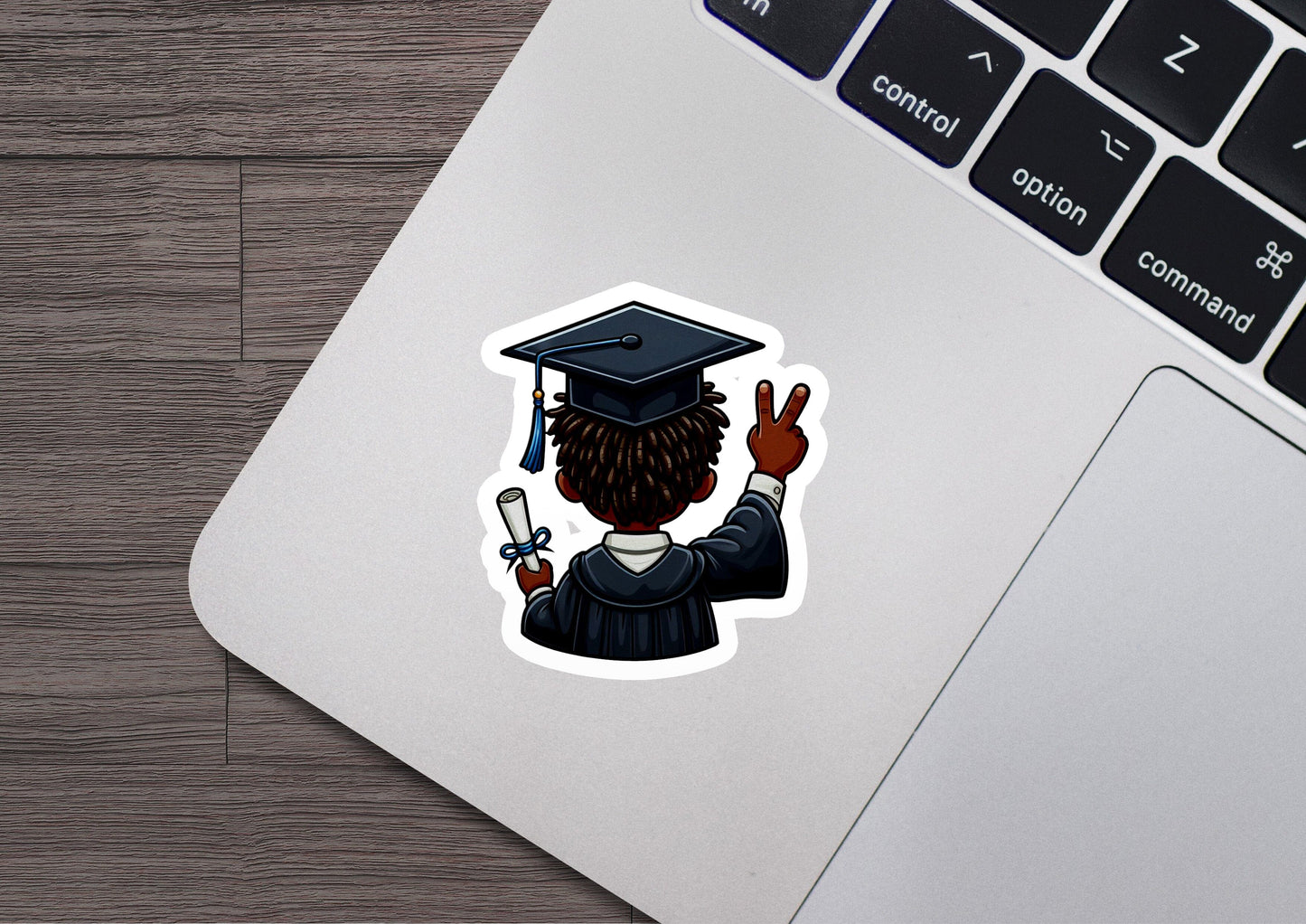 a laptop with a sticker of a graduate