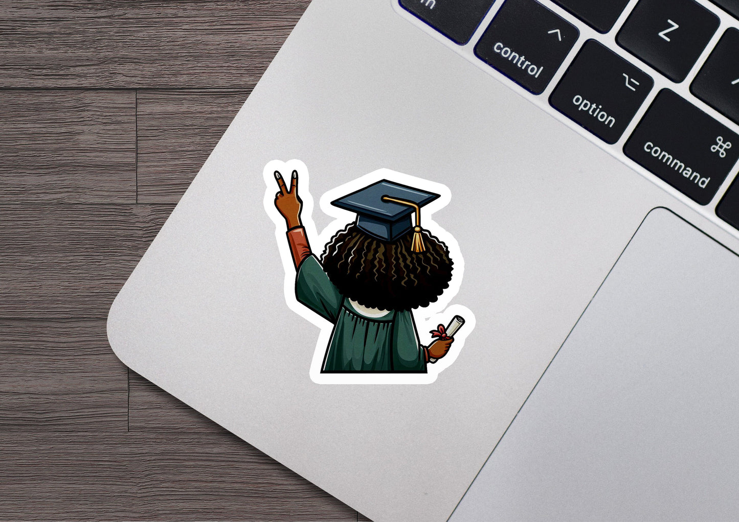 a laptop with a sticker of a man in a graduation cap
