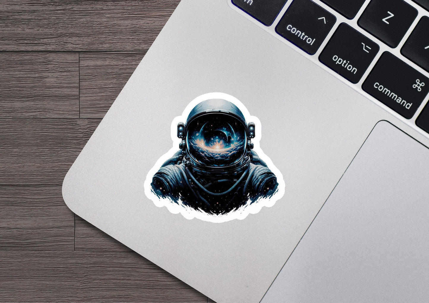 a laptop with a sticker of an astronaut