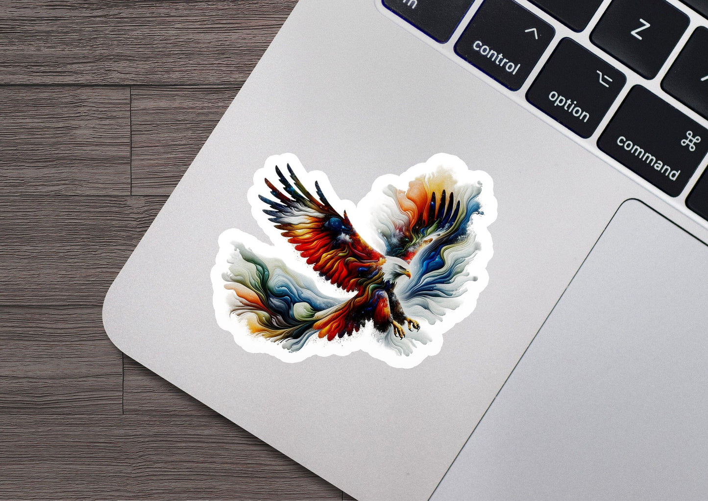 a sticker of a bird flying on top of a laptop