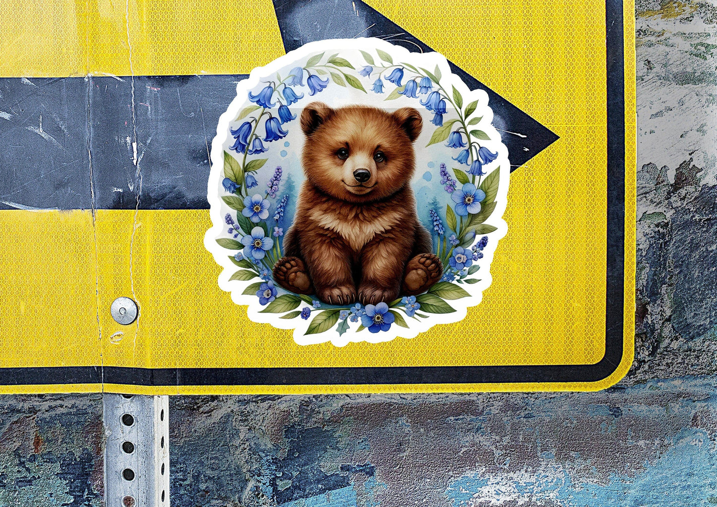 a sticker of a brown bear sitting on top of a yellow sign
