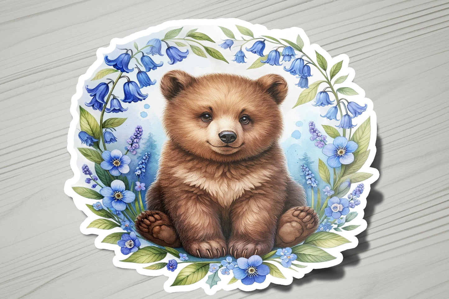 a sticker of a brown bear surrounded by blue flowers