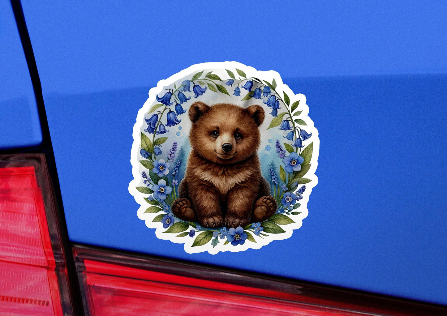 a sticker of a brown bear on a blue car