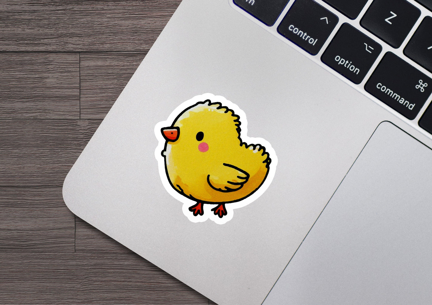 a sticker of a yellow chick on a laptop