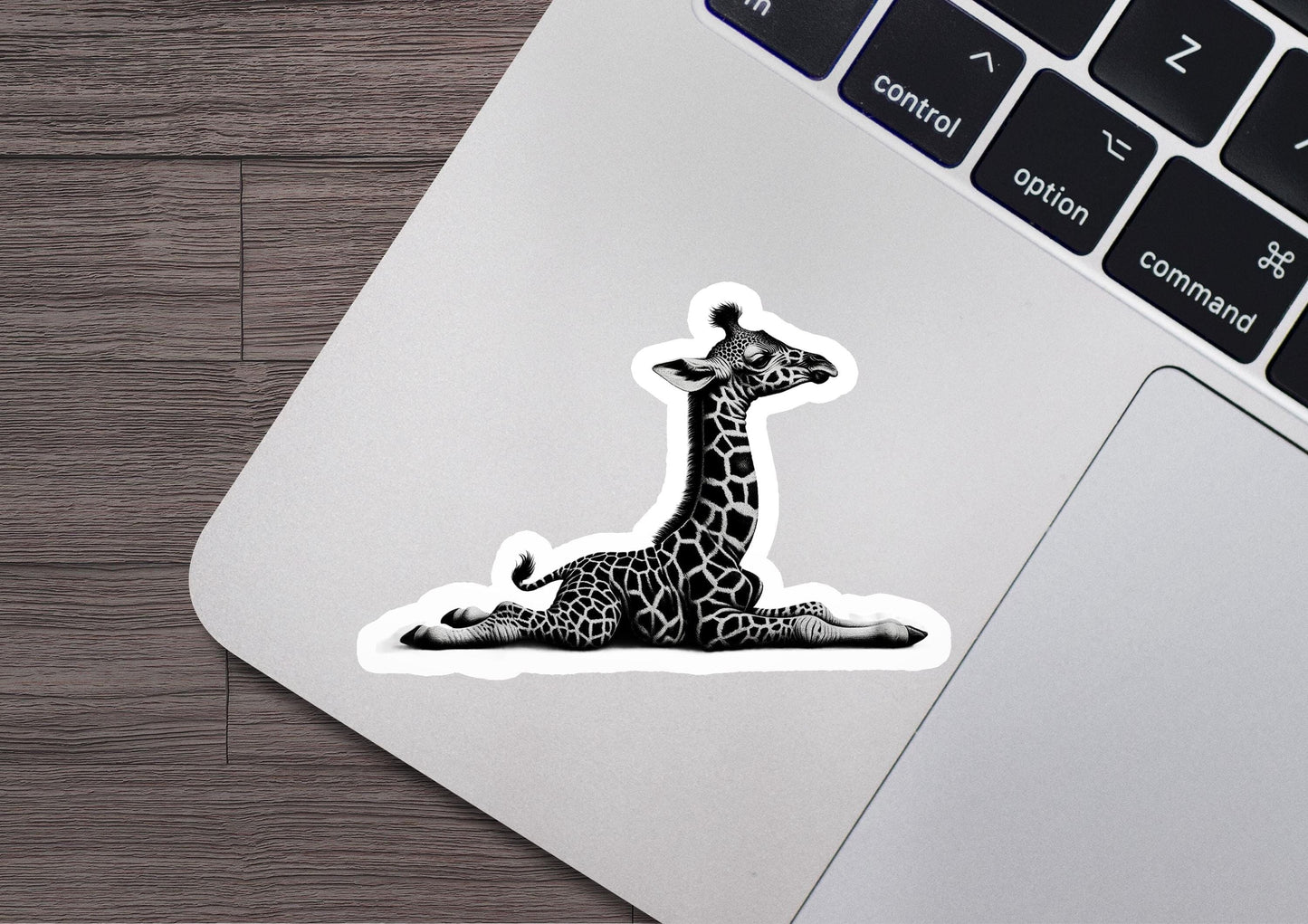 a sticker of a giraffe sitting on a laptop