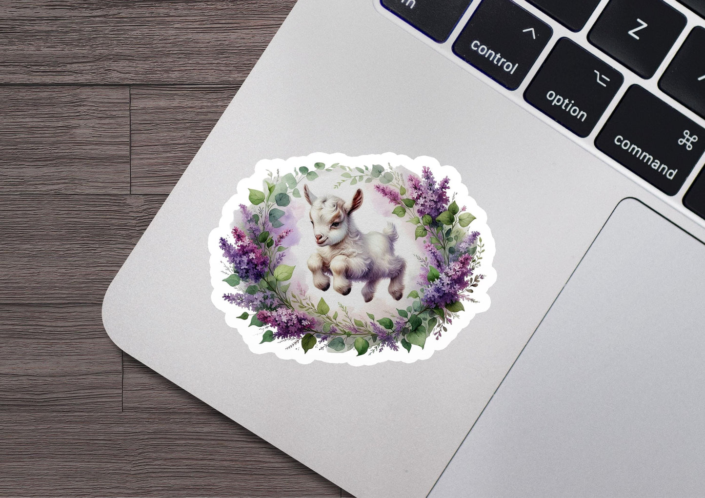 a sticker of a baby goat surrounded by flowers