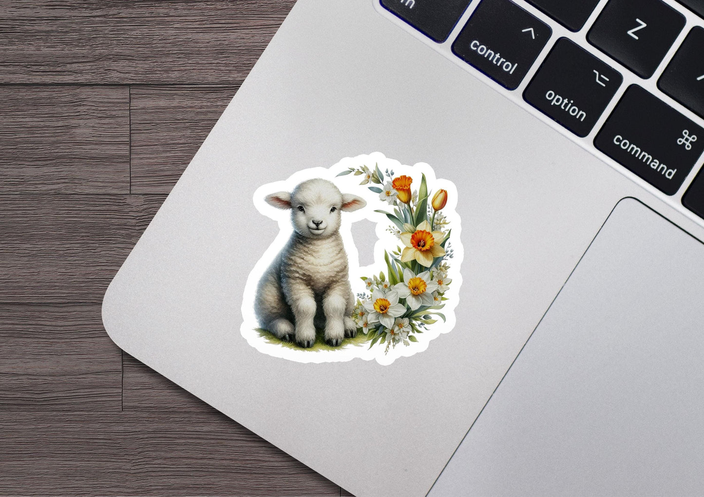 a sticker of a lamb sitting on top of a laptop
