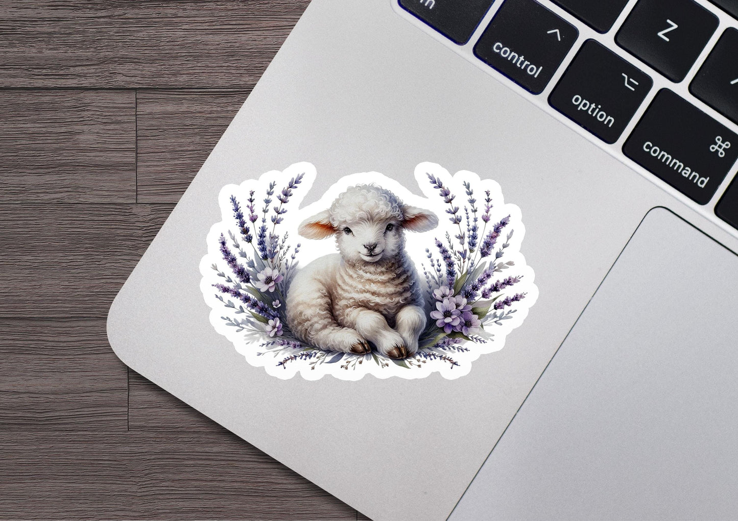 a sticker of a sheep sitting on top of a laptop