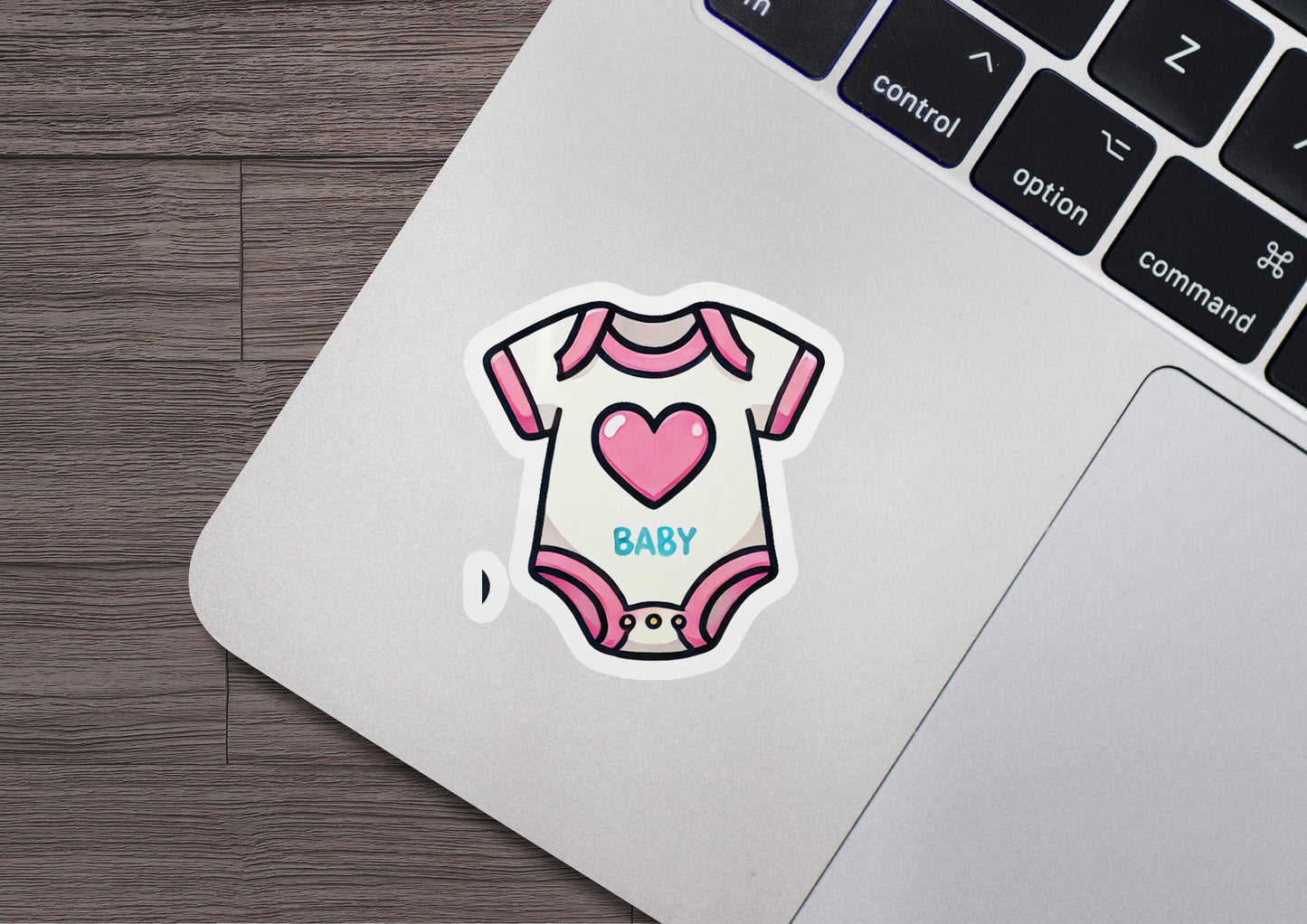a laptop with a sticker of a baby's bodysuit