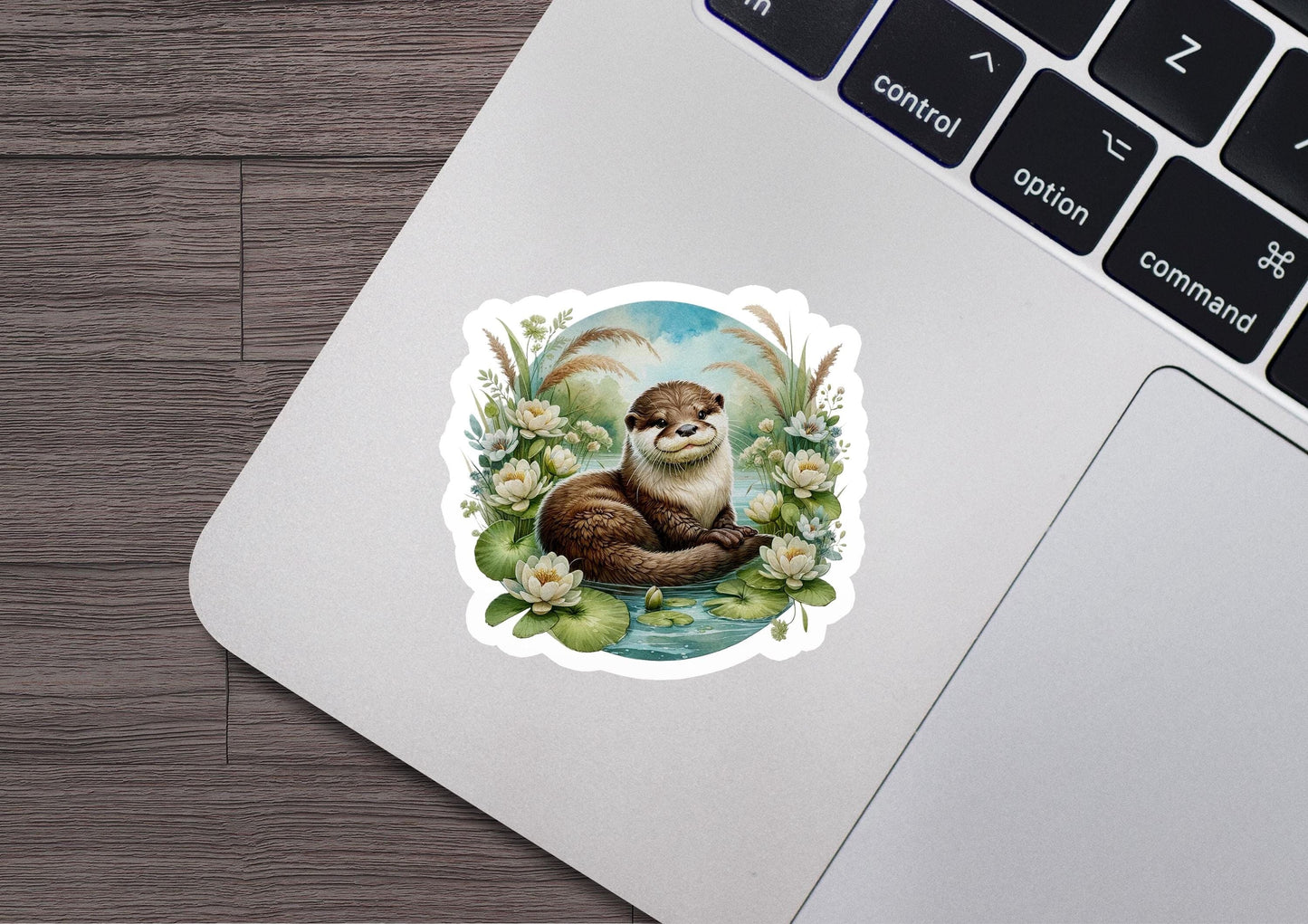 a sticker of a otter sitting on a laptop keyboard