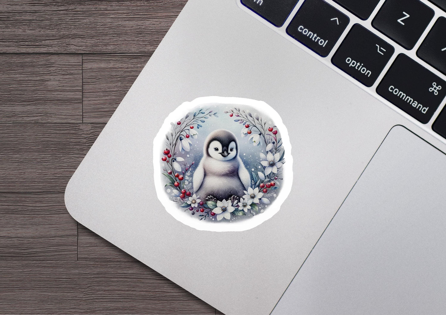 a sticker of a penguin sitting on a laptop