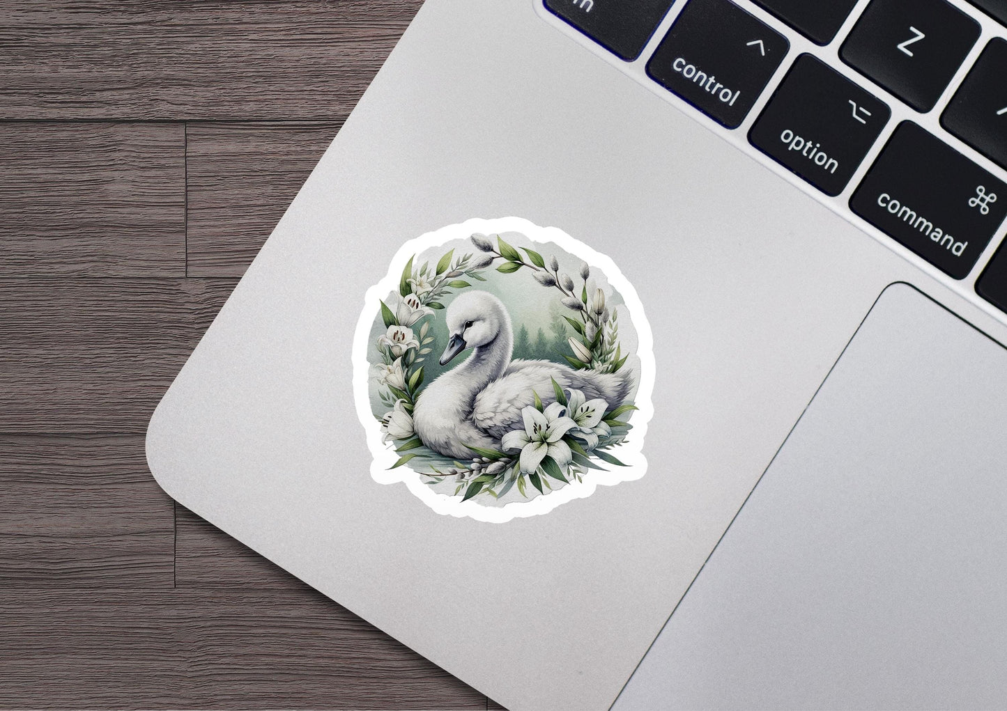 a laptop with a sticker of a bird and flowers on it