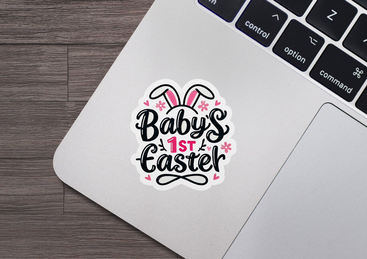 a laptop with a sticker that says baby's 1st easter