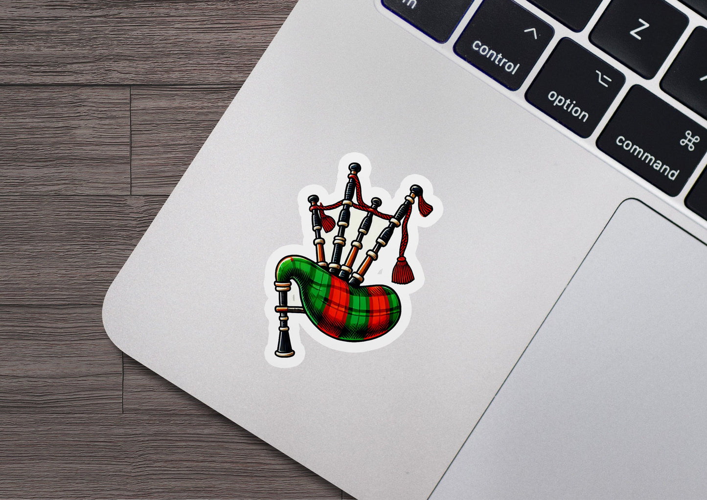 a laptop with a sticker of a musical instrument