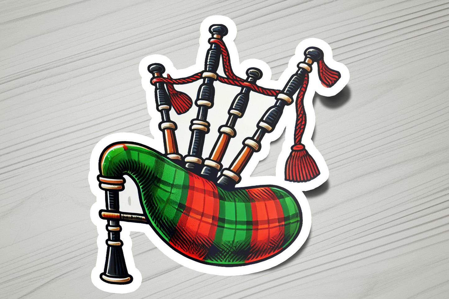 a sticker of a bagpipe with a red and green tartan