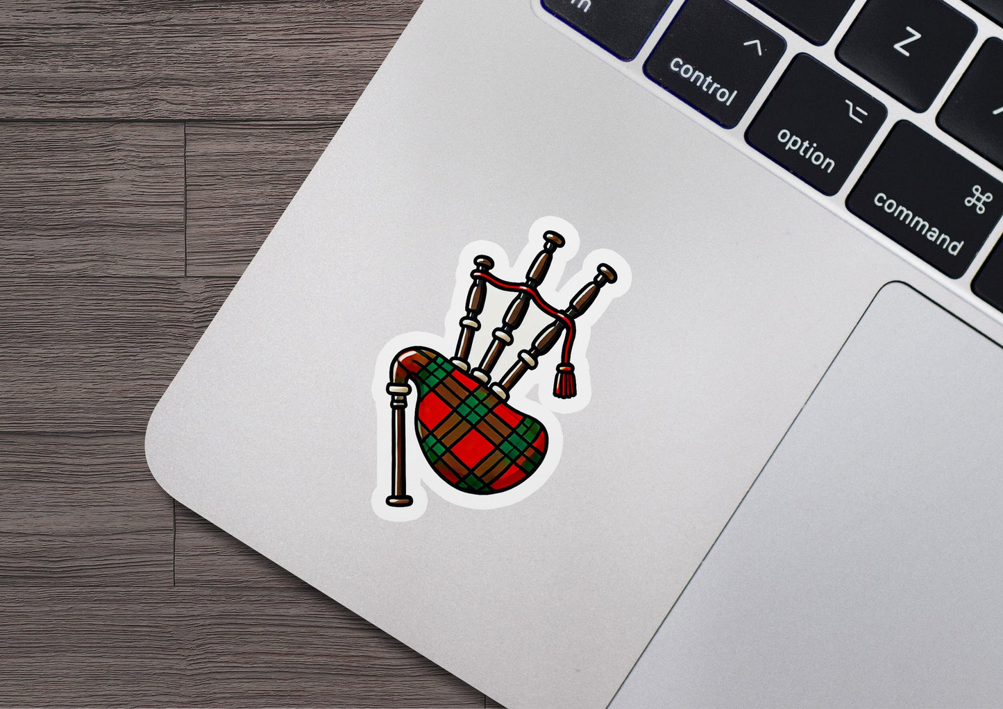 a laptop with a sticker of a bagpipes on it