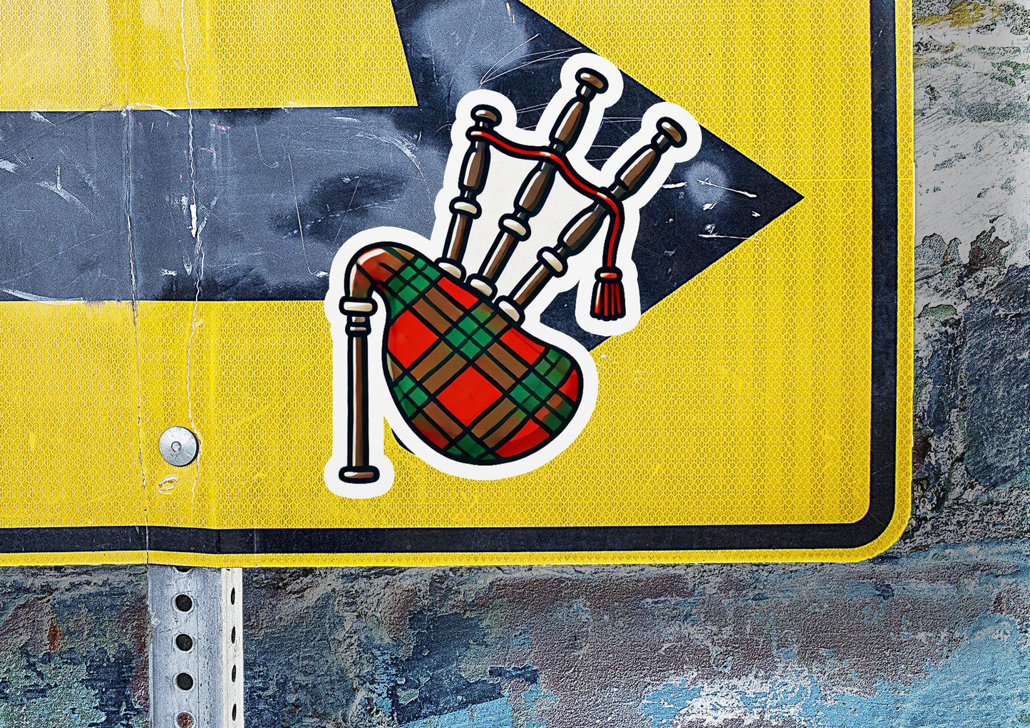 a yellow street sign with stickers on it