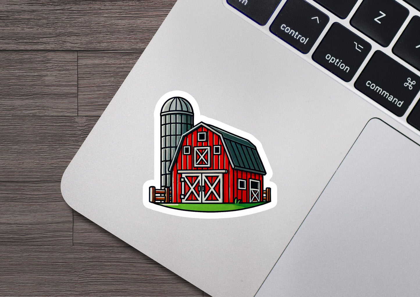 a red barn sticker on a laptop