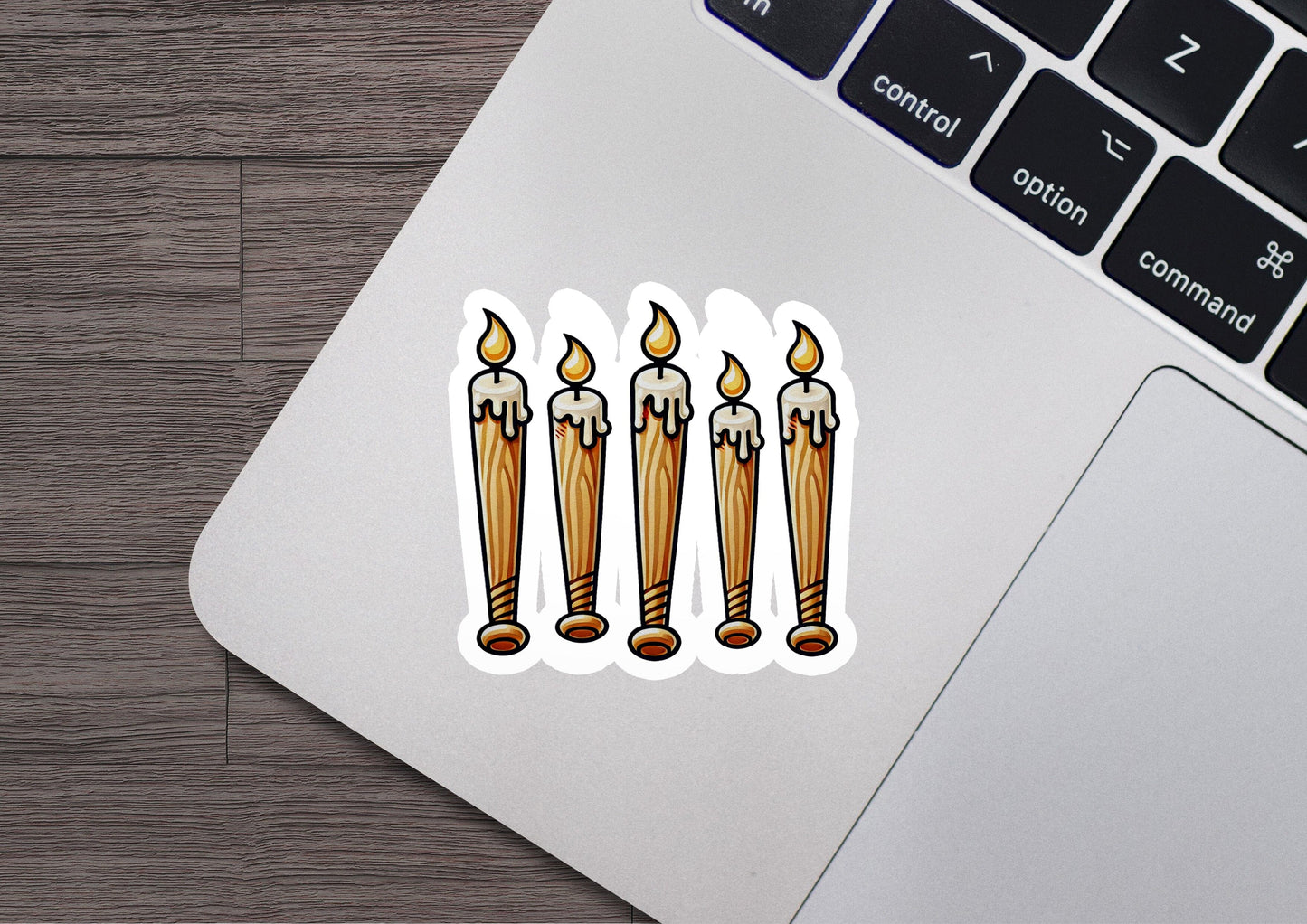 a laptop with a sticker of three candles on it