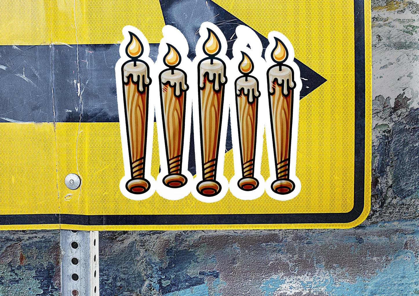 a street sign with stickers of candles on it