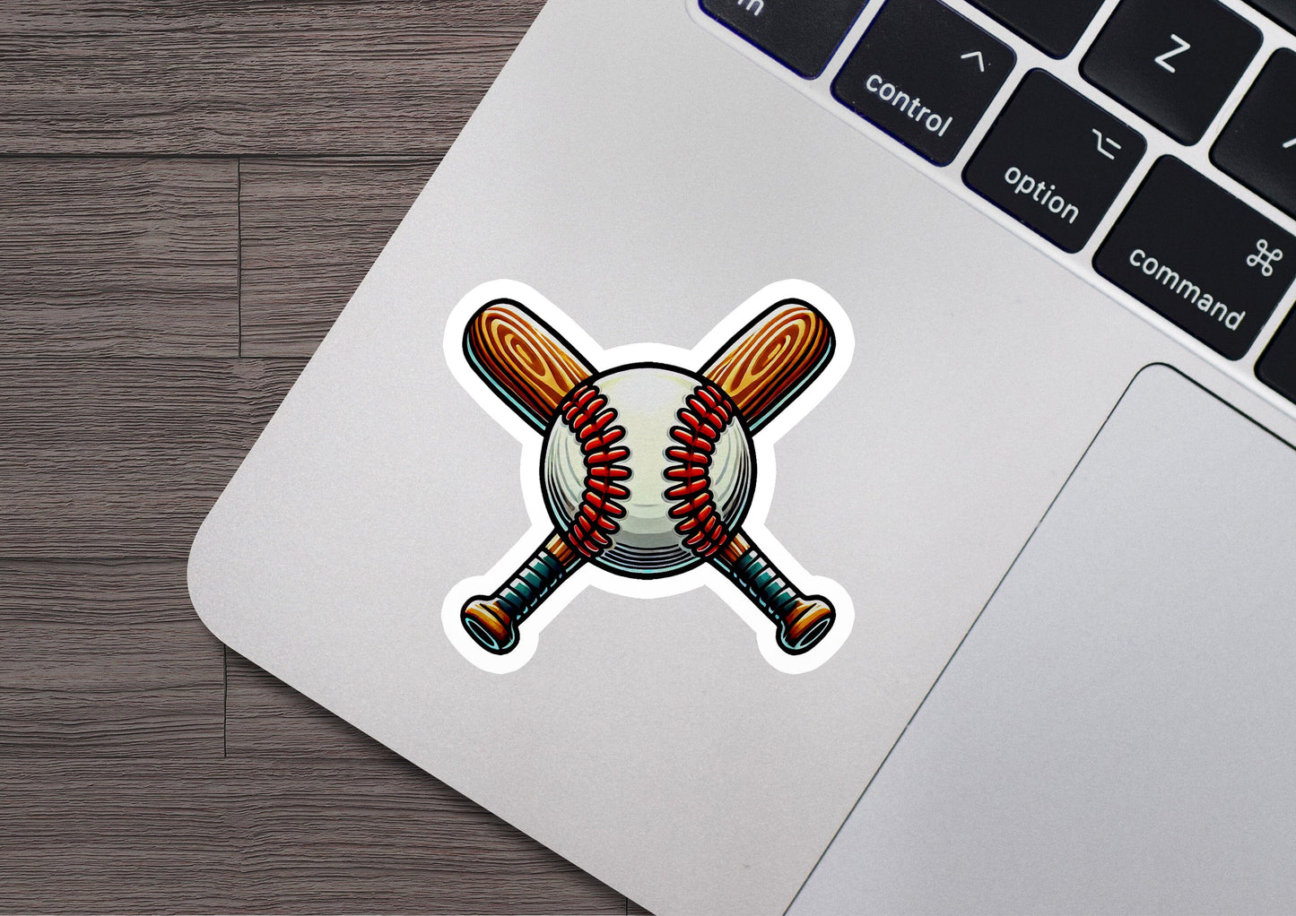 a laptop with a sticker of a baseball bat and ball