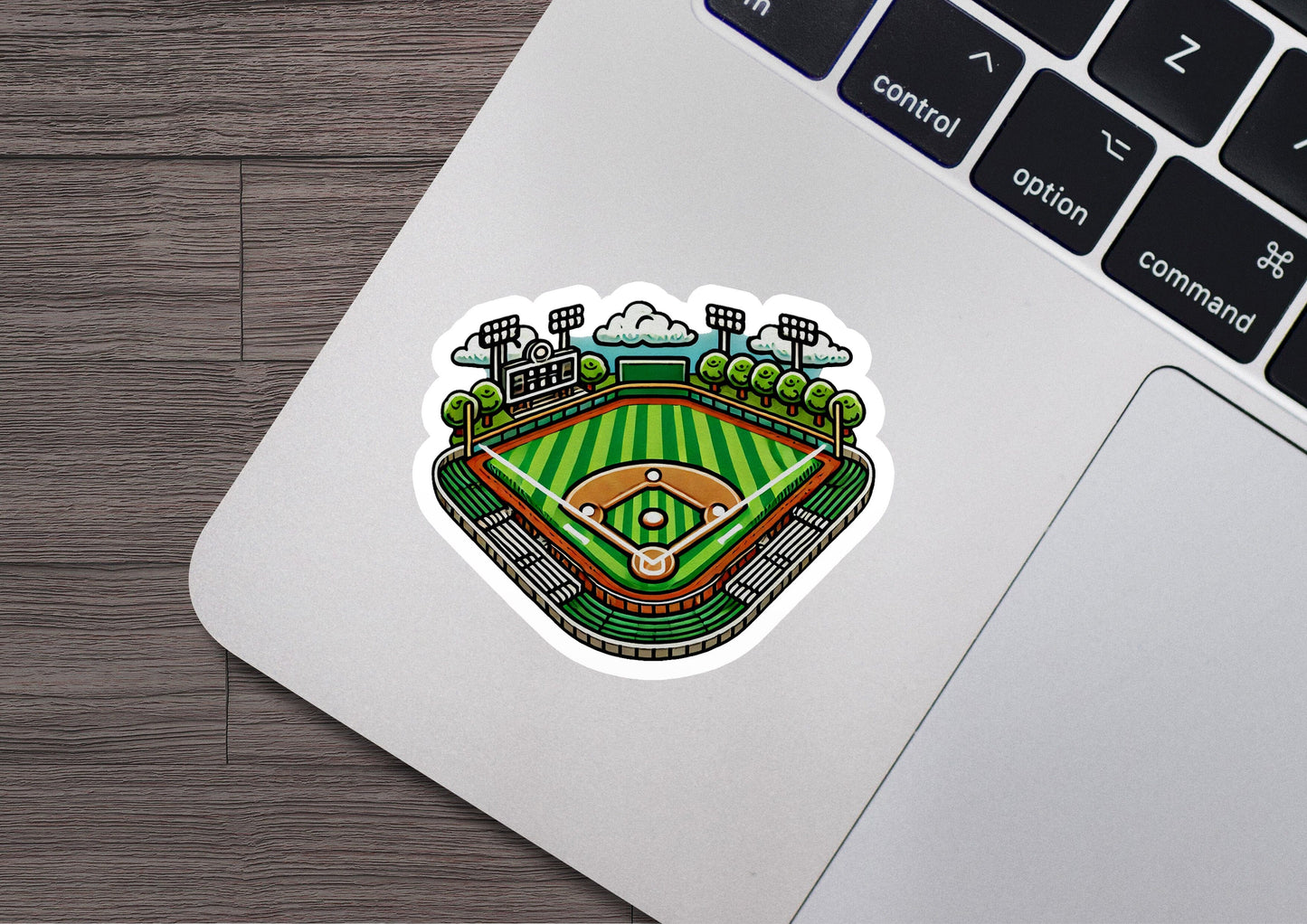 a laptop with a sticker of a baseball field