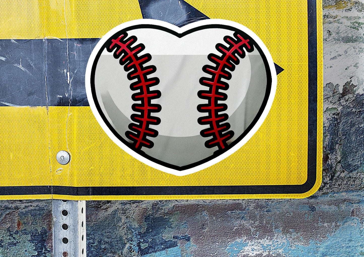 a heart shaped baseball sticker on a street sign