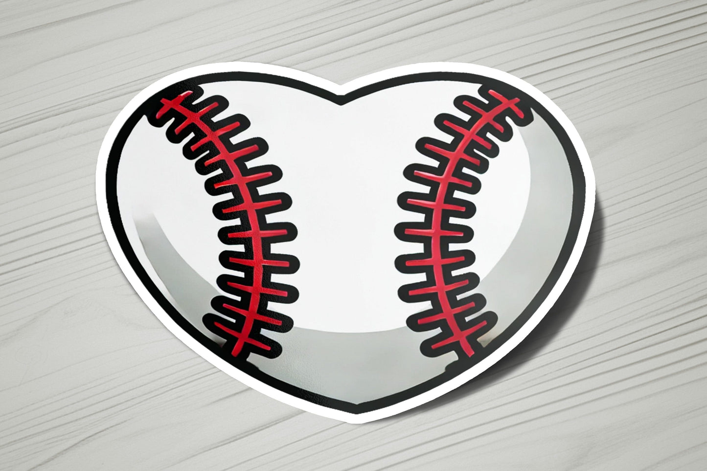 a heart shaped sticker with a baseball on it