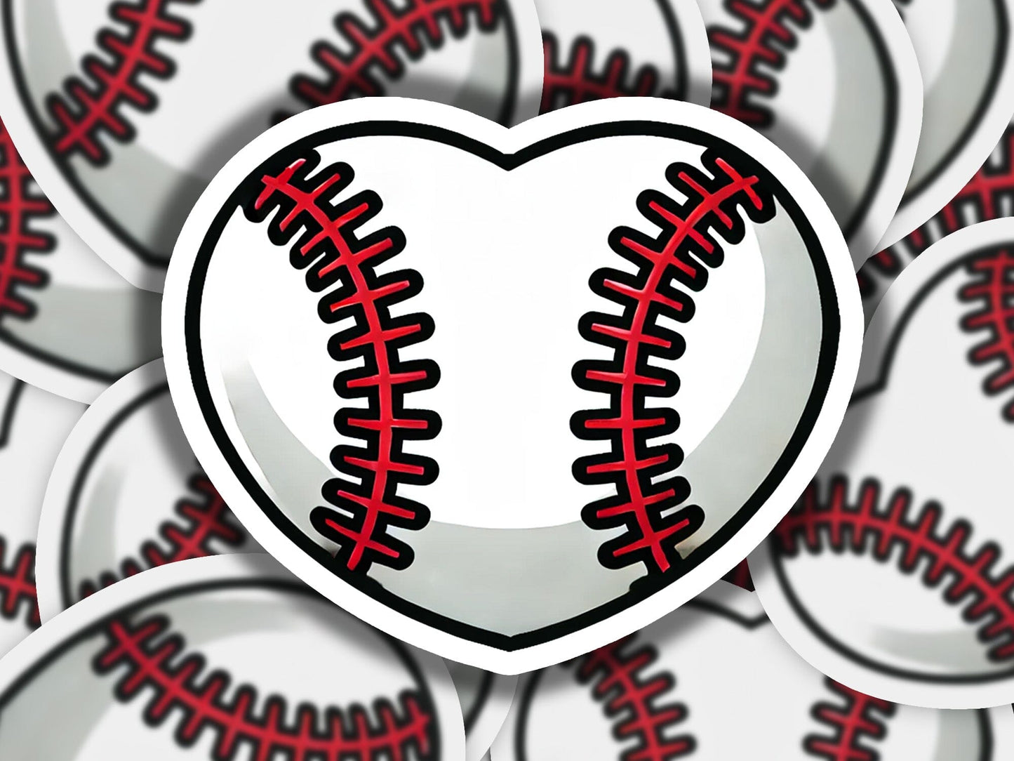 a heart shaped sticker with a baseball pattern on it