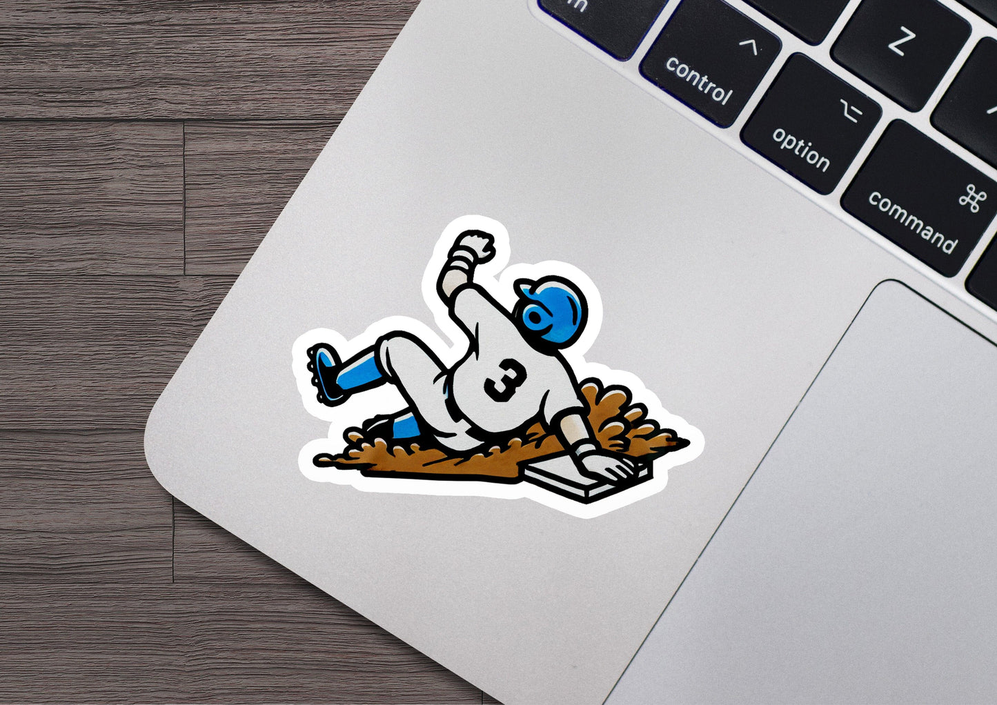 a sticker of a baseball player sliding into a base