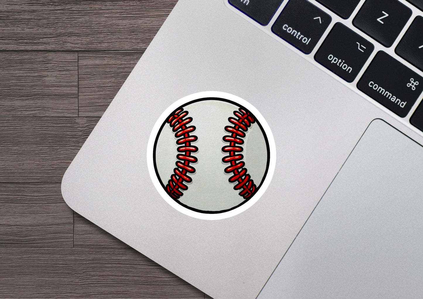 a laptop with a sticker of a baseball on it