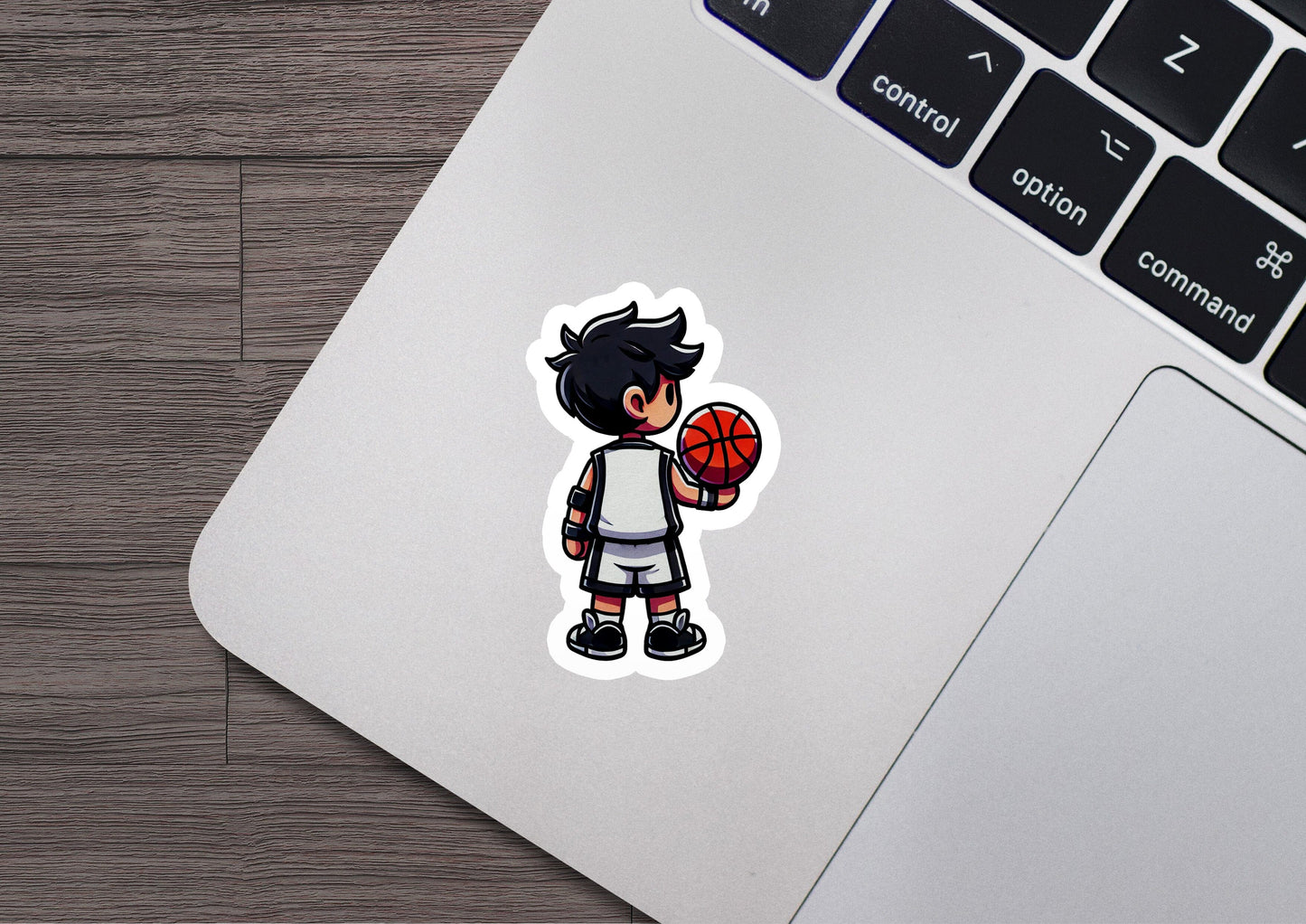 a laptop with a sticker of a boy holding a basketball