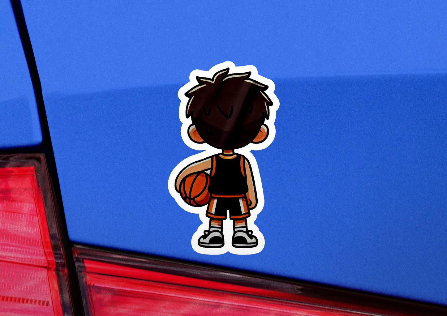 a sticker of a boy with a basketball in his hand