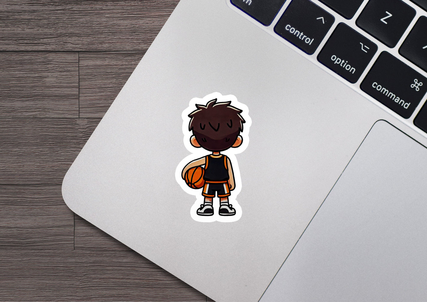 a laptop with a sticker of a basketball player