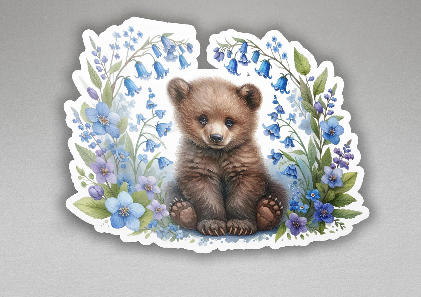 a sticker of a brown bear surrounded by blue flowers