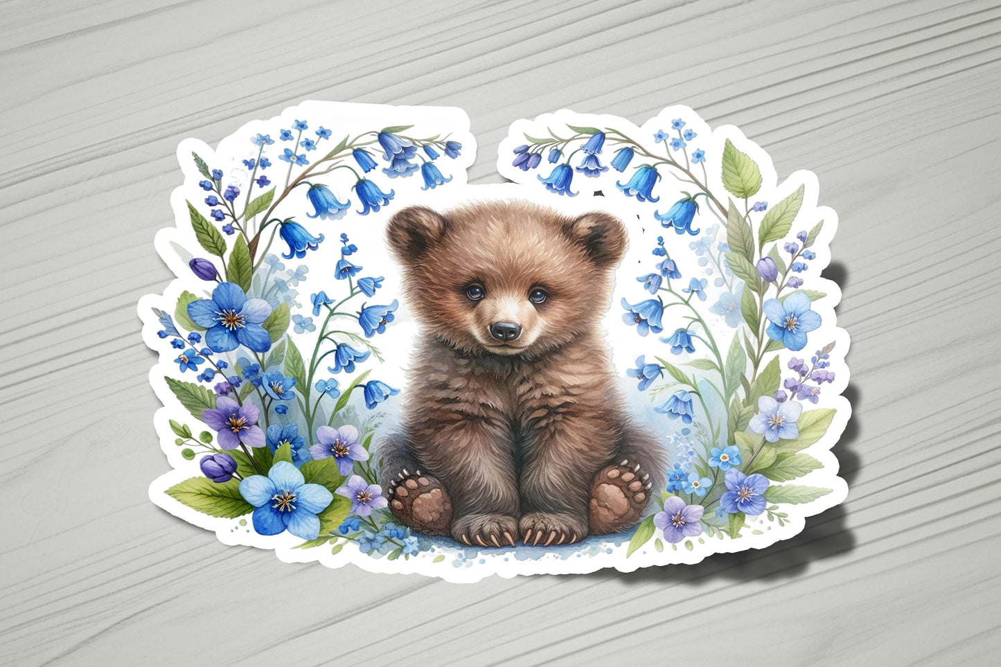 a picture of a brown bear surrounded by blue flowers