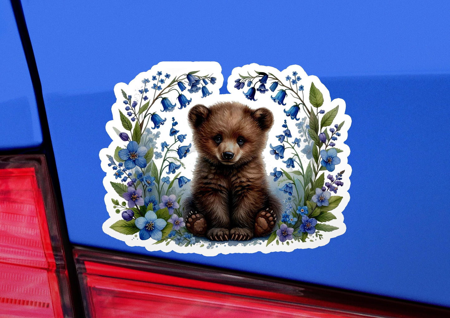 a sticker of a brown bear sitting on the back of a car