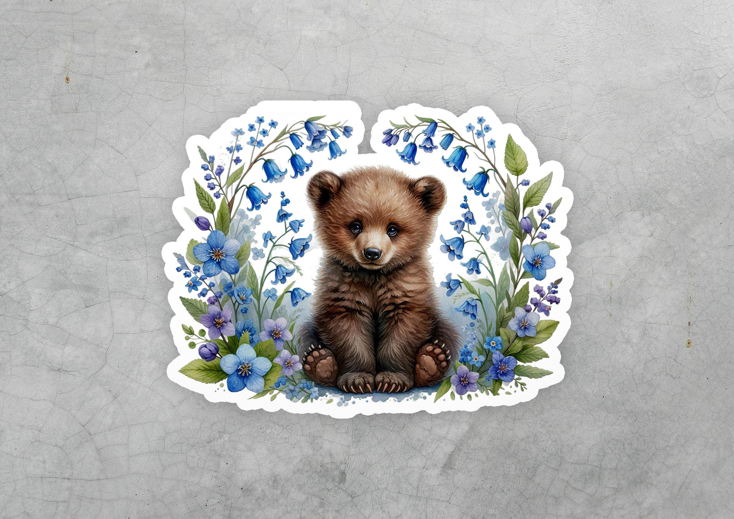 a sticker of a brown bear surrounded by blue flowers