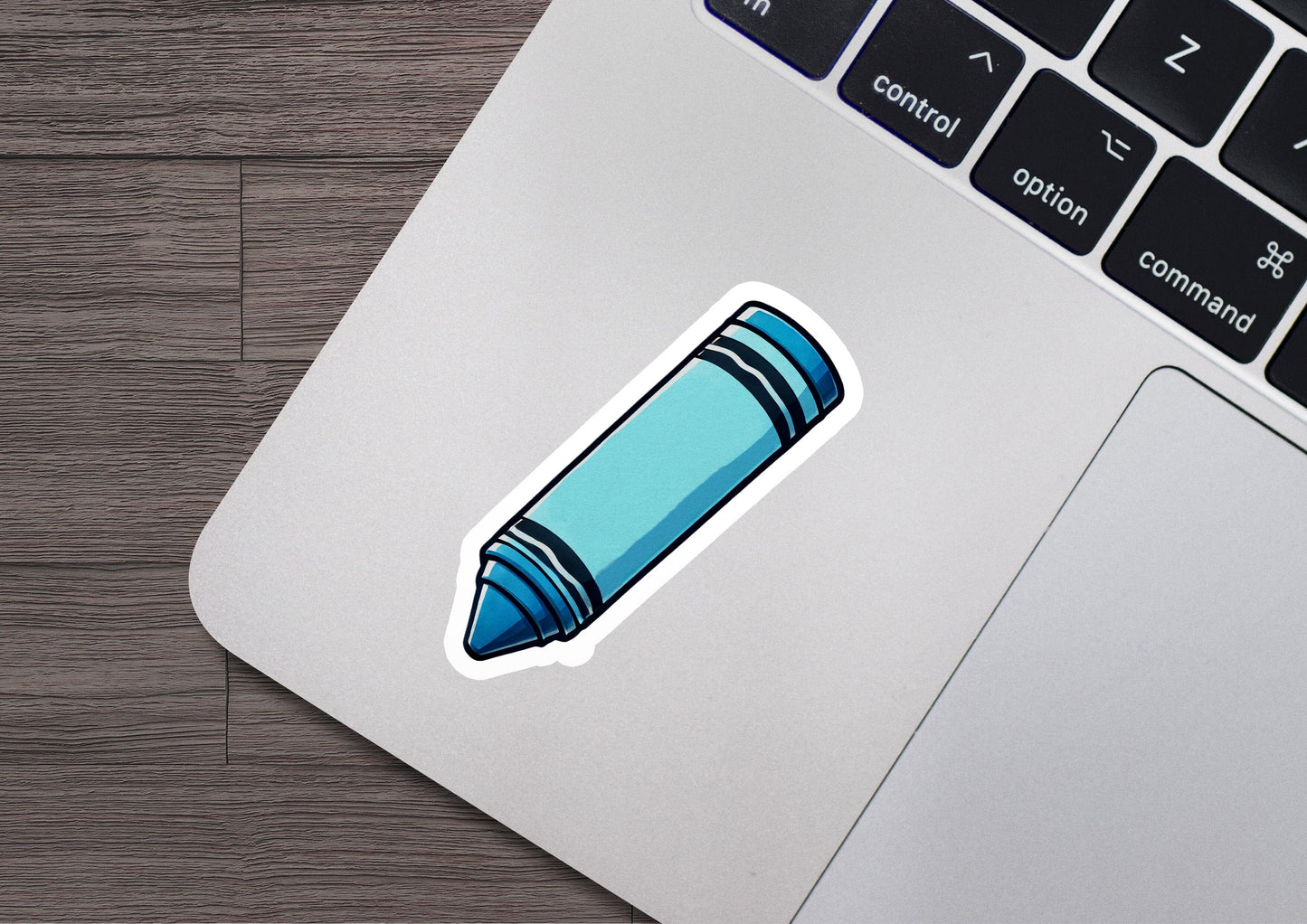 a sticker of a blue crayon crayon on a laptop