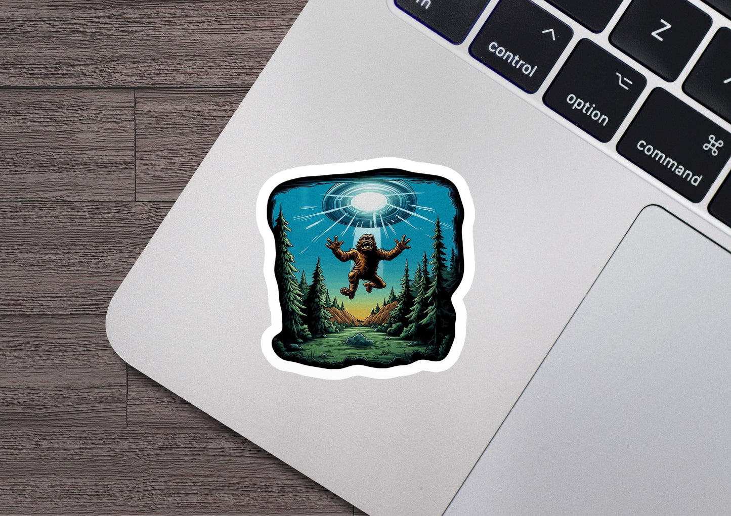 a laptop with a sticker of a man flying over a forest