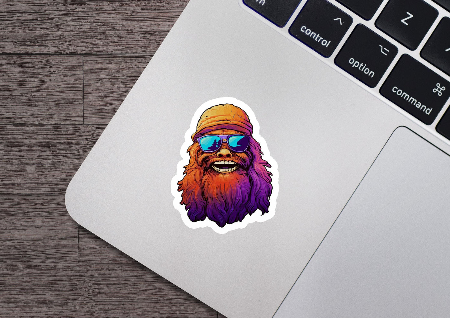 a laptop with a sticker of a bearded man