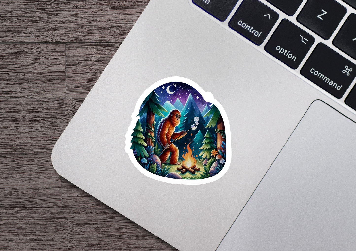 a laptop with a sticker of a bear in the woods