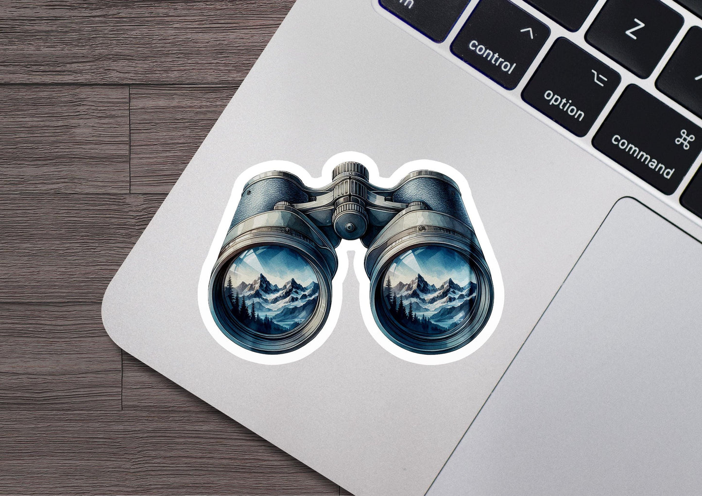 a laptop with a sticker of a pair of binoculars