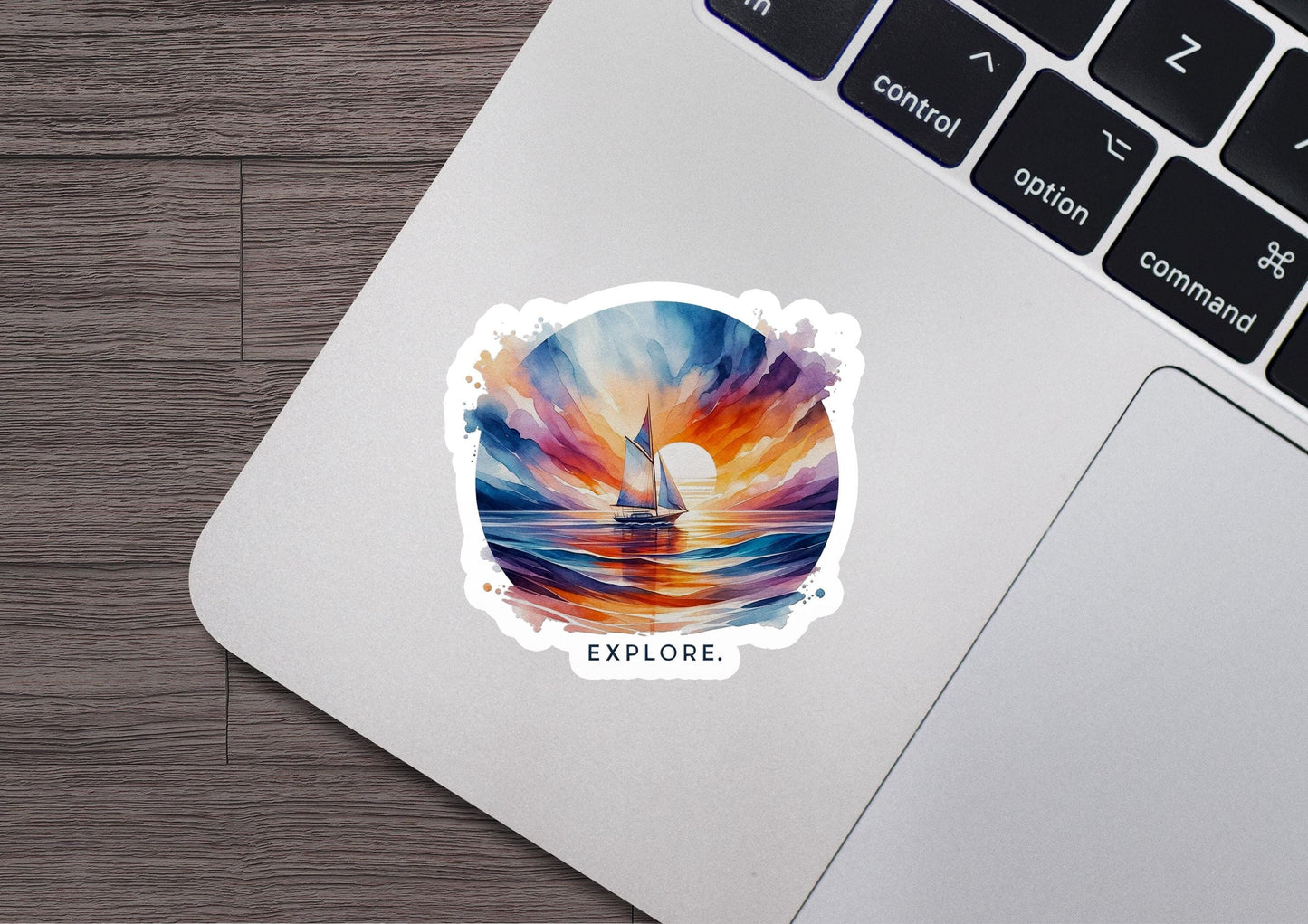 a laptop with a sticker of a boat in the ocean